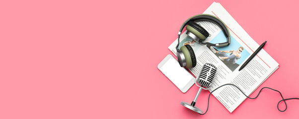 Headphones with microphone, mobile phone and newspaper on pink background with space for text