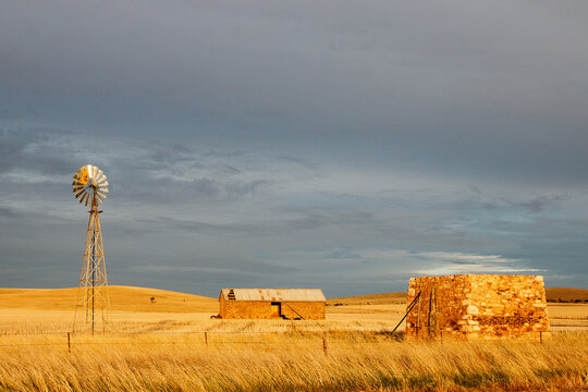old stone farm buildings in golden light