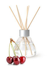 Reed diffuser and cherry on white background
