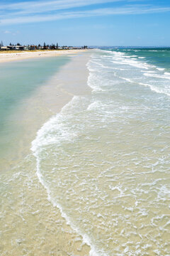 waves washing over sand bar at city beach