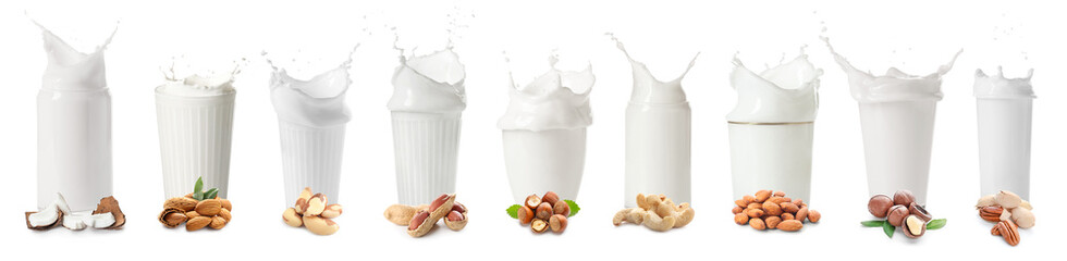 Set of glasses with splashing vegan milks on white background