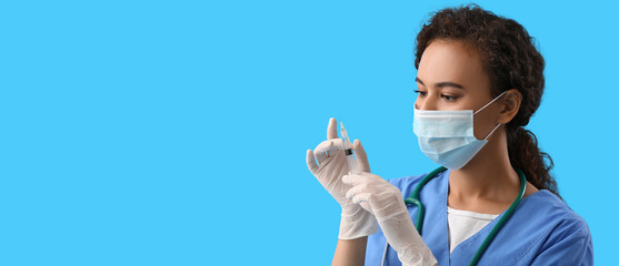 African-American nurse with syringe on blue background with space for text