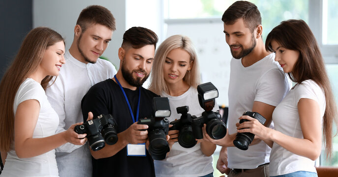 Group of young photographers during master class in studio