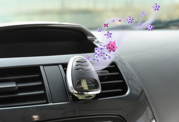 Aroma air freshener with flying fresh lilac flowers in car salon