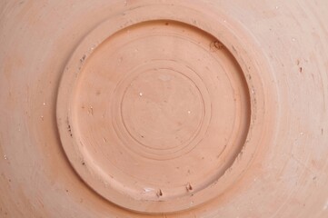 Close up of round earthenware bottom copy space