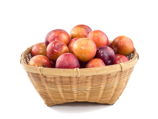Juicy red Plum fruits in basket isolated on white background.
