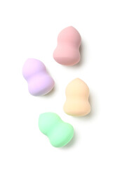 Colorful makeup sponges on white background, top view