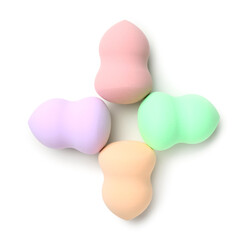 Colorful makeup sponges on white background, top view