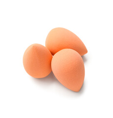 Orange makeup sponges on white background