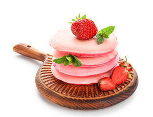 Wooden board with stack of pink pancakes and strawberry on white background