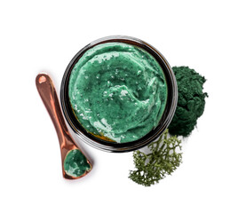 Jar of spirulina facial mask on white background