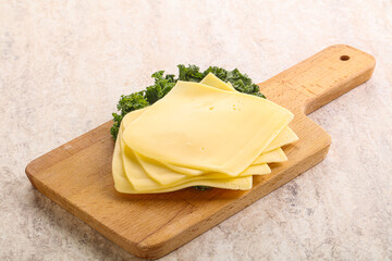 Sliced Gouda cheese over board