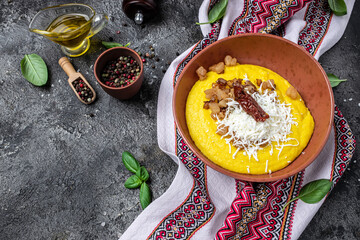 banosh with corn porridge cheese and lard on a dark background. Ukrainian cuisine. Food recipe...