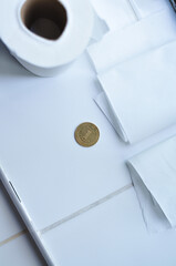Roll of white toilet paper and golden Ukrainian hryvnia coin. Translation from Ukrainian :one hryvnia, Ukraine