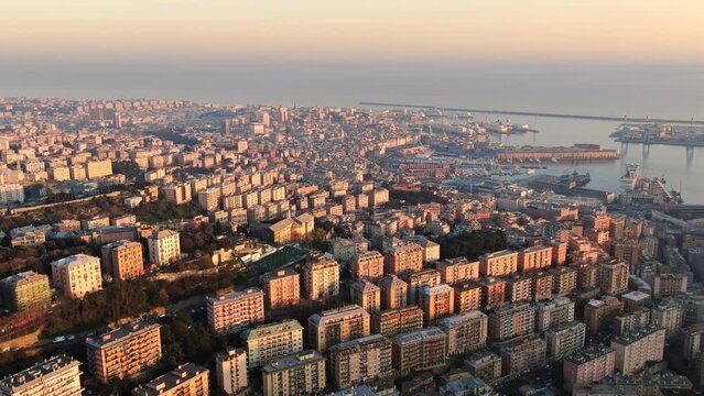 aerial shot drone of genoa city at sunset view of old town seafront,view of genova town from above liguria italy 4k