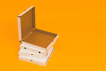 pizza box open on yellow background with copy space