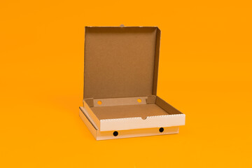 pizza box open on yellow background