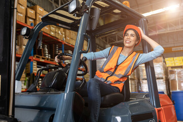 Fototapeta na wymiar Happy woman worker warehouse staff forklift driver happy smiling enjoy working Asian people.