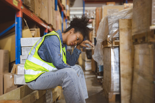Tired stress woman worker labor working in warehouse cargo inventory industry.