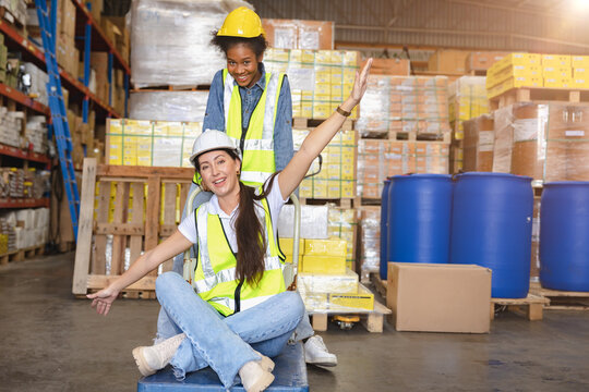 Women warehouse employee worker enjoy working teamwork with friend happy smile at workplace.
