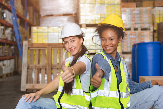 Women warehouse employee worker enjoy working teamwork with friend happy smile at workplace.