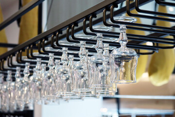 Wine and cocktail glasses hanging upside down in a bar