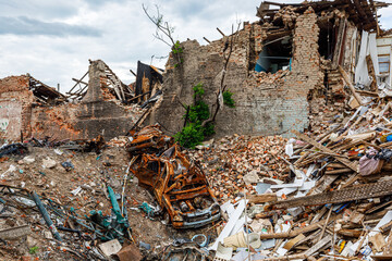 civilian car destroyed by Russian troops under the rubble. Residential area Saltovka. War in...