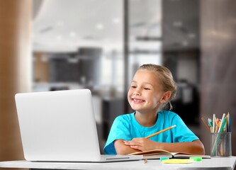 Naklejka na ściany i meble Portrait of smiling child studying at home, homeschooling concept