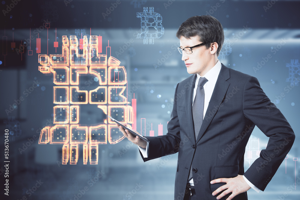 Poster Cryptocurrency trading and investing concept with handsome man in suit using digital tablet on abstract background with digital graphic illuminated bitcoin sign