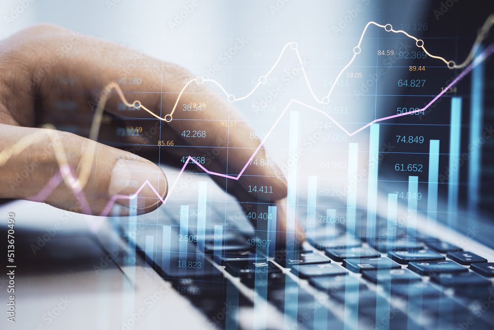 Poster businessman hand using laptop keyboard at desktop with abstract glowing business chart with index and growth on blurry background. Finance, trade and market report concept. Double exposure.