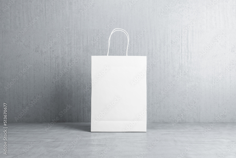Poster front view on blank white paper shopping bag with space for your logo or text on concrete floor on g