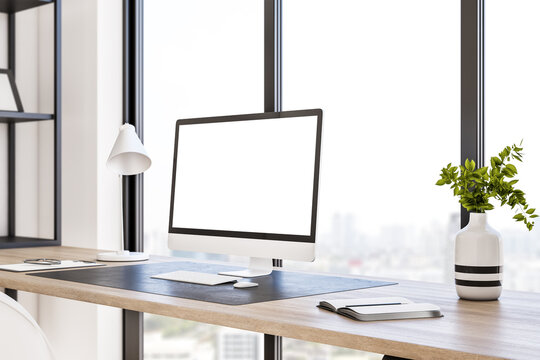 Perspective view on blank white modern computer monitor with space for your logo or text on stylish wooden table on panoramic window background with city view. 3D rendering, mock up