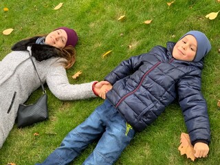 couple on the grass. mother and son. Autumn