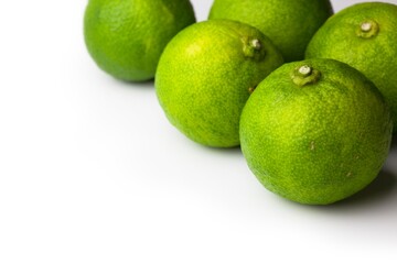 Asian kabosu lime ( Citrus sphaerocarpa ),.Often used on Asian cooked fish, sashimi, and hot pot dishes,  isolated on white.