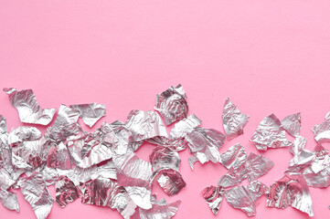 Sheets of steel foil on pink background copy space. High quality photo