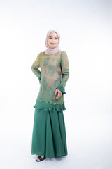 Naklejka premium Beautiful female model in poses wearing traditional apparel and hijab, an urban lifestyle look for Muslim women isolated on white background. Beauty and hijab fashion concept. Full length