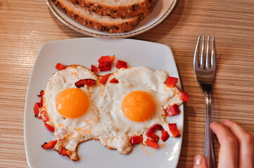 Two Fried eggs on pan with red pepper morning breakfast . High quality photo