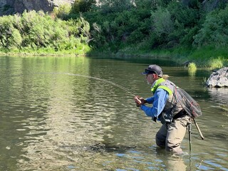 catch of a beautiful rainbow trout by a fly fisherman in Montana