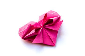 Pink paper heart origami isolated on a white background