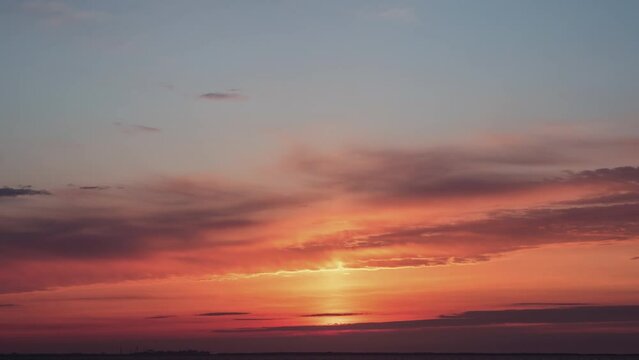 View of colorful sunset with clouds. Time-lapse.