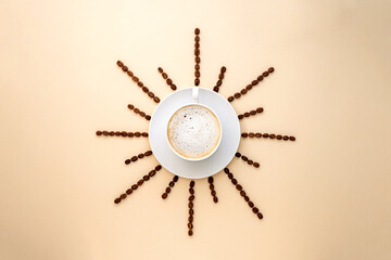 Coffee abstract, creative concept, coffee cup and coffee beans beans on warm, neutral background.