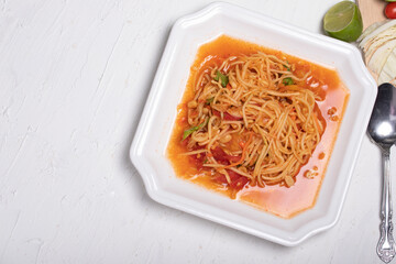 Thai papaya salad in a white plate Popular dishes on a white background