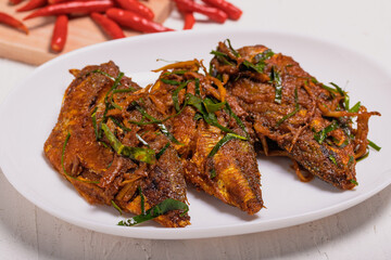 Fried fish with Thai red curry paste