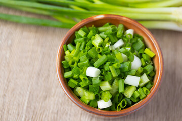 Sliced spring onions in a ceramic cup