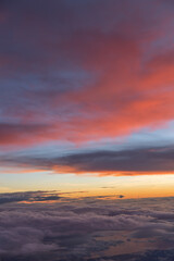 Pink sunset clouds out of airplane window