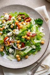 Cabbage green salad. Healthy fresh salad with tomatoes, parsley, onions, salad cheese, chickpeas. Detox, healthy food