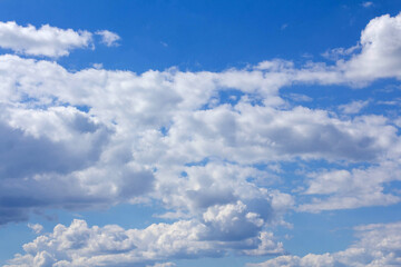 textured white clouds on blue sky background