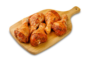 Marinated thighs on cutting board on white background