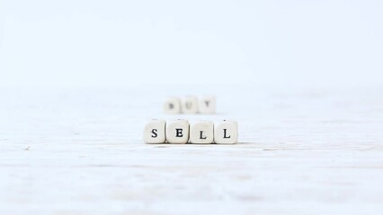 Wooden blocks with Buy sign being swapped to Sell. High quality 4k video. - Powered by Adobe