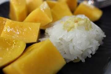 Thai style mango with sticky rice with sprinkle of crunchy friend yellow lentil dal